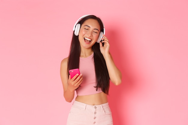 Waist-up portrait of attractive stylish asian girl close eyes