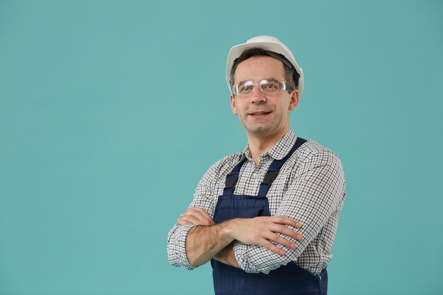 Waist up portrait of professional worker or builder smiling at camera