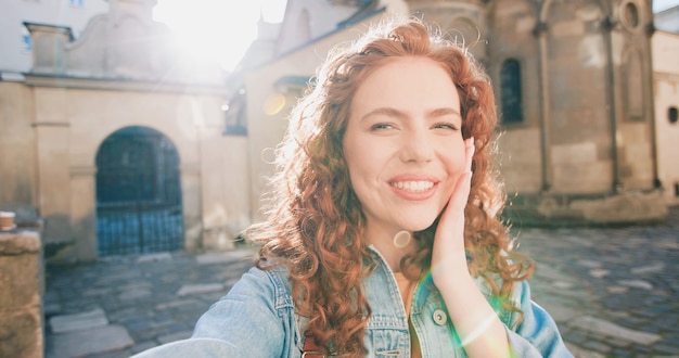 Waist up portrait view of the caucasian female person wearing casual clothes taking video at the sel...