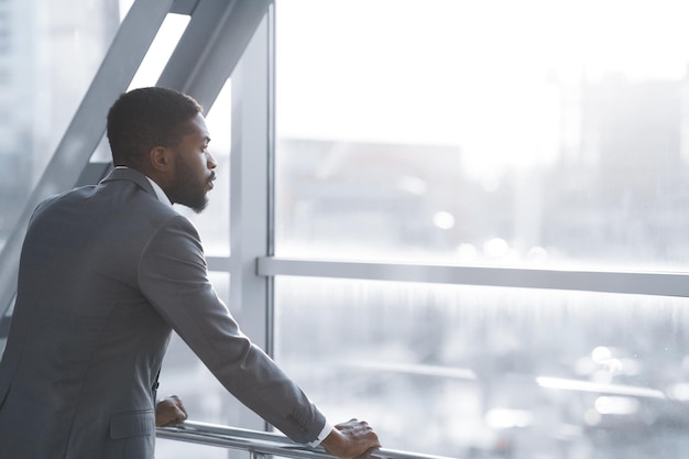 Wait for Flight Afro Businessman Looking Through Window