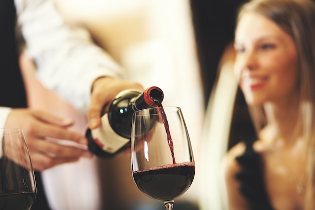 Waiter pouring wine