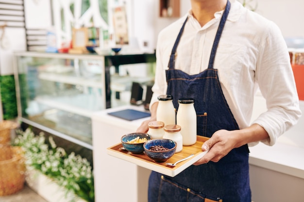 Waiter serving breakfast