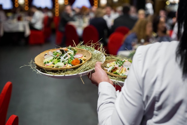 Waiter serving food in a restaurant