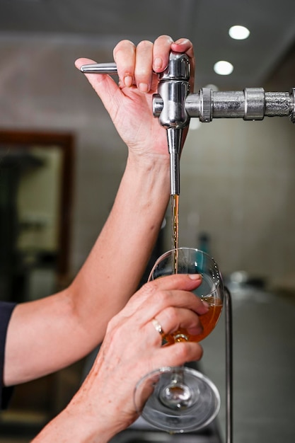 Waiter serving a frozen glass of draft beer