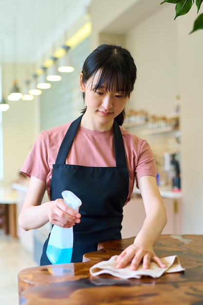 Waitress cleaning table after guest