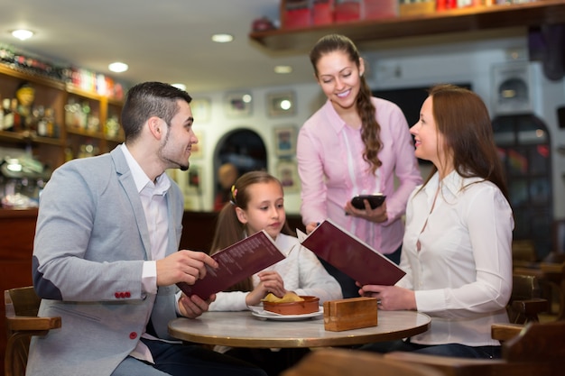 Waitress serving family of three