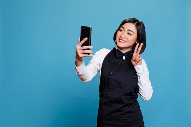 Waitress taking selfie on smartphone