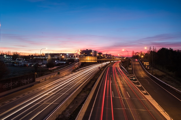 Wake of lights on highway at dawn