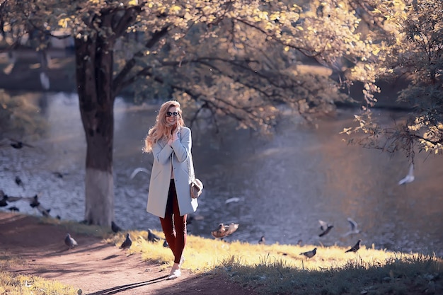 walk in autumn park / beautiful girl in autumn park, model female happiness and fun in yellow trees  October