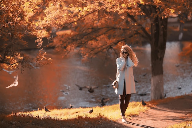 walk in autumn park / beautiful girl in autumn park, model female happiness and fun in yellow trees  October