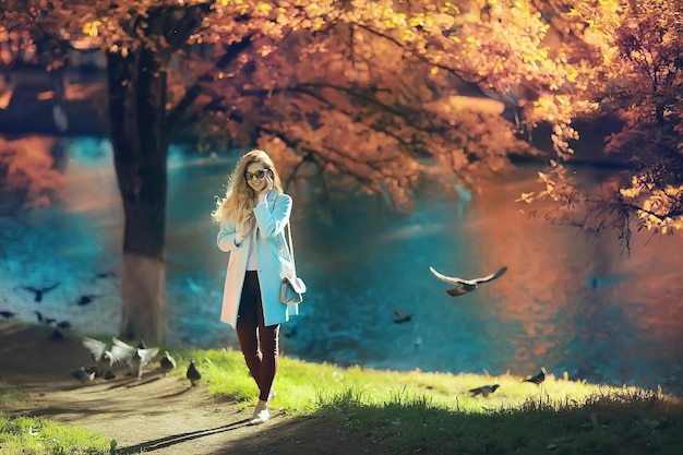 walk in autumn park / beautiful girl in autumn park, model female happiness and fun in yellow trees  October