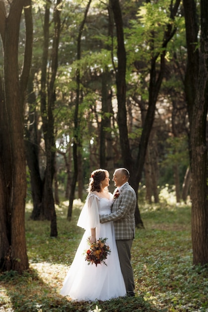 Walk of the bride and groom through the autumn forest in October