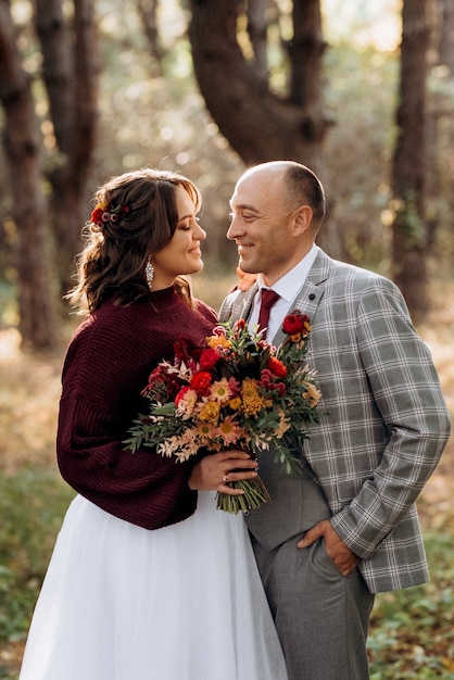 Walk of the bride and groom through the autumn forest in October