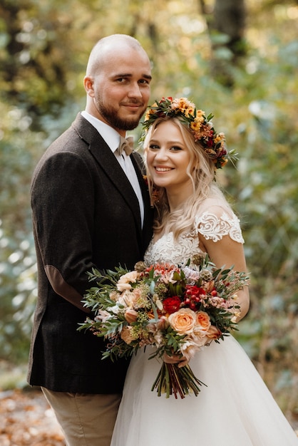 Walk of the bride and groom through the autumn forest