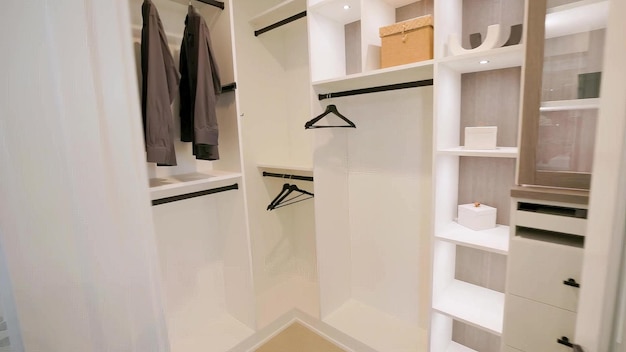 a walk in closet with a box on the left side