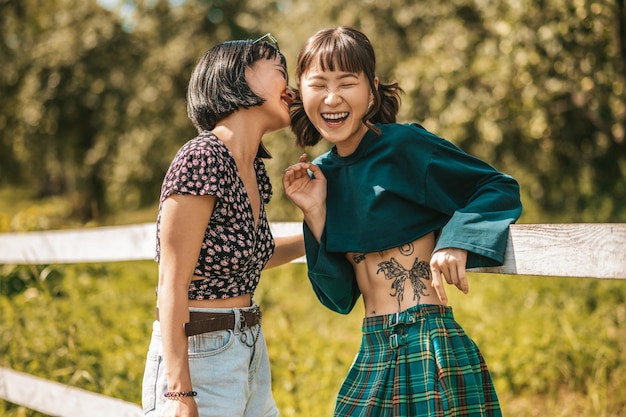 Walk in the park. Sweet girls looking happy and ejoyed while spending time together