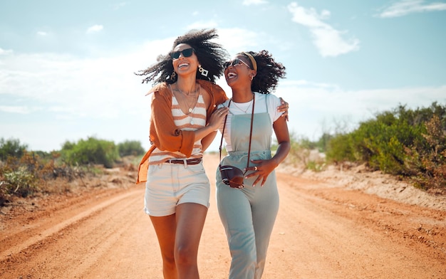 Walking happy and friends on holiday at a safari during summer together in nature of Kenya Happy playful and young African women on vacation in the desert for travel freedom and adventure