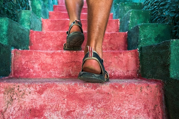 Walking upstairs closeup view of man legs