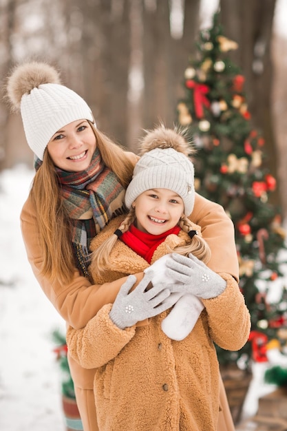 Walking in the winter park with my younger sister among the snow and p