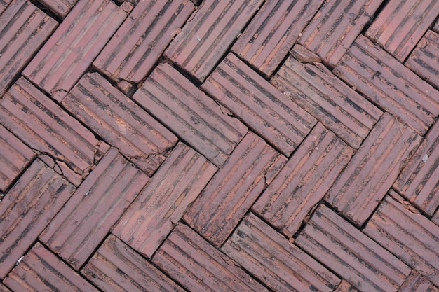 Walkway is paved with brown bricks