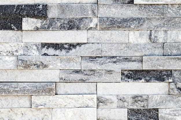 Wall background masonry of marble flat slabs of different lengths