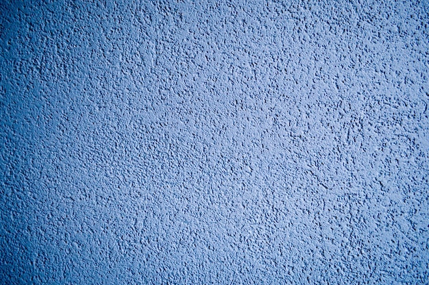 Wall of blue rough embossed building decorative stucco Texture background