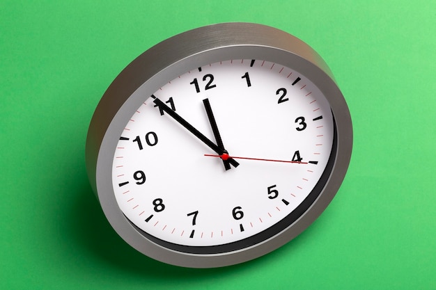 Wall clock on a green surface