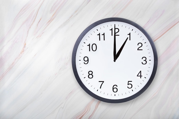 Wall clock on marble texture show one o'clock Office clock show 1pm or 1am