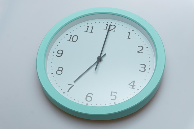 Wall clock showing various times on a white background