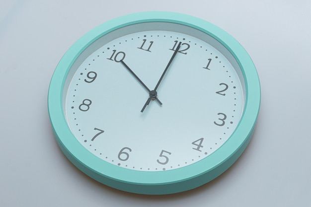 Wall clock showing various times on a white background