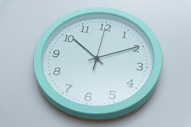 Wall clock showing various times on a white background