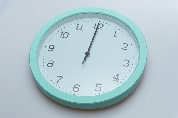 Wall clock showing various times on a white background