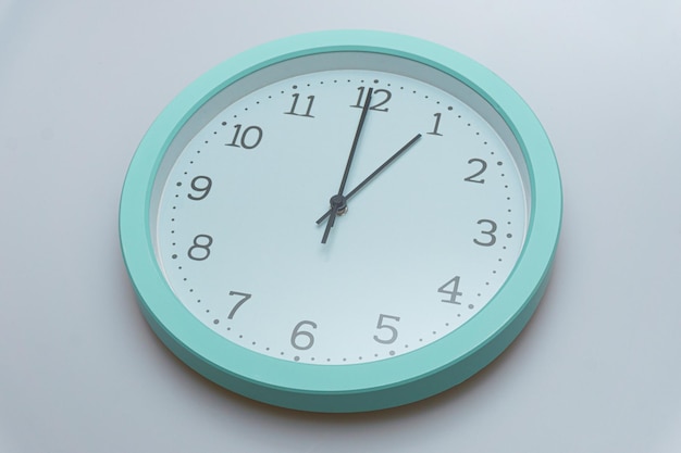 Wall clock showing various times on a white background