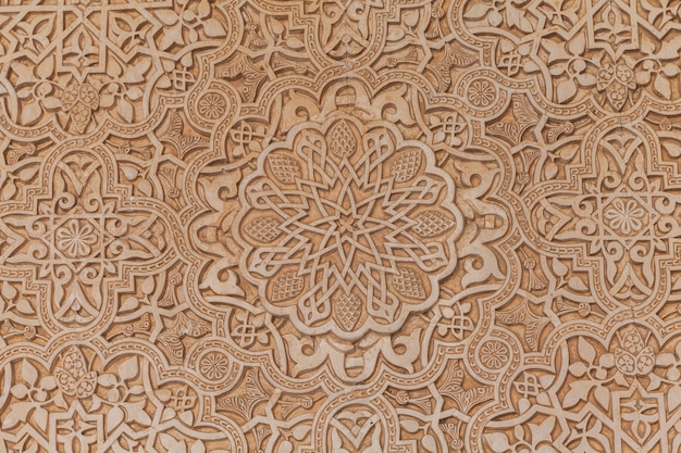 Wall detail of Alhambra UNESCO site in Granada - South of Spain. 600 years old arabic characters.