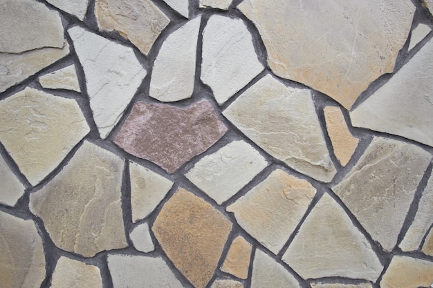 The wall lined with decorative stone. Abstract stone background