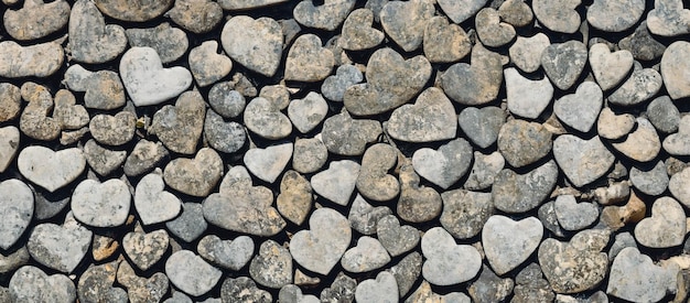 A wall made of heart shaped stone blocks, 3d render