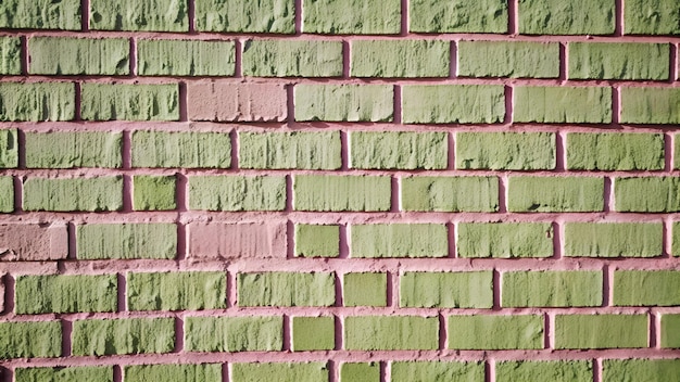 Photo wall made of mint and pink bricks texture of old colored brick wall panoramic background