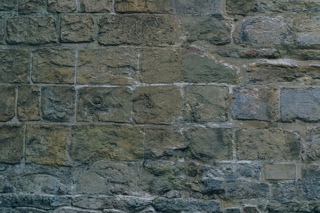 A wall made of stone bricks with a rough texture