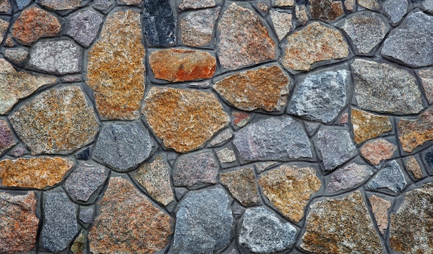 a wall made of stones with a cross on it.