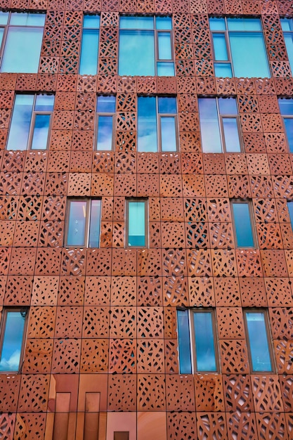 Wall of red steel with cutouts and windows in New York City