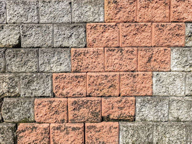 The wall surface is made of bricks in two colors Taken outside of a strong land where there are shadows