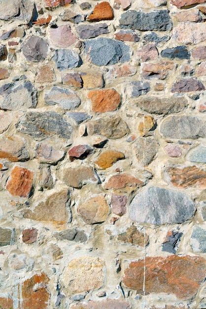 A wall of uneven stones Vintage building stone background