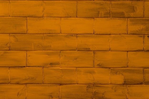 Wall with bricks textured and colored in dark yellow