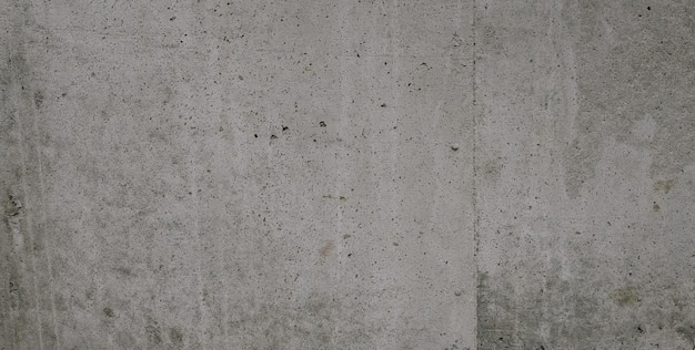 A wall with a cement texture and a black and white sign that says " the word " on it. "