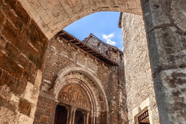 Wall with columns of church Eglise Saint Pierre de Carennac with medieval tympanum Lot France