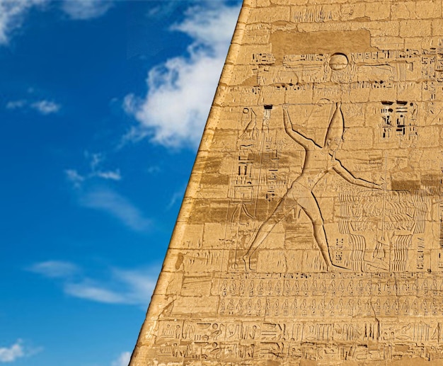 A wall with a relief of a woman with a sign that says'egyptian'on it