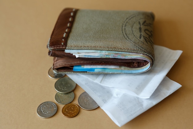 Wallet with money coins and cashiers check from store