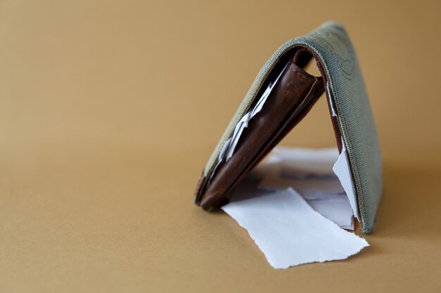 Wallet with pieces of paper instead of money