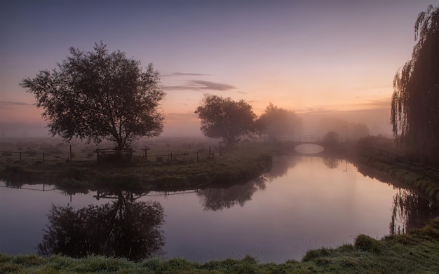 Wallpaper of small bridge over misty creek