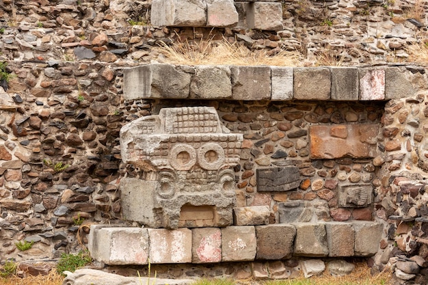 The walls of the pyramid are decorated with stone carvings. Teotihuacan, Mexico